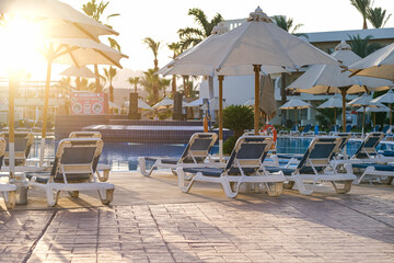 Sunbeds near swimming pool at luxury resort