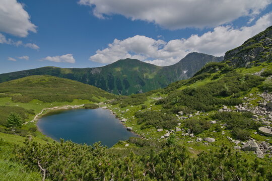 View to one of four Rohacske plesa mountain lakes in Vysoke Tatry mountains. Lakes  are 1719 metres above the sea surrounded by mountains peaks more than 2000 metres above the sea. Slovak nature.