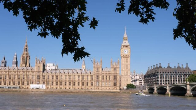 View of London, Houses of Parliament building with Big Ben. British history, Palace of Westminster, river bank. High quality 4k footage