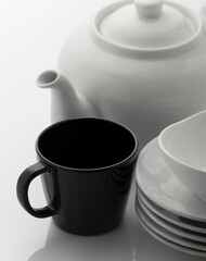 Crockery and cups, white on white crockery and black crockery