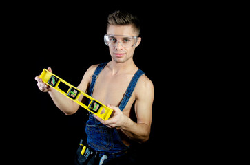 Young attractive handyman posing in a photo studio.