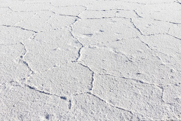 Exploring the huge salt flats Salinas Grandes de Jujuy in northern Argentina while traveling South America - close up of the surface