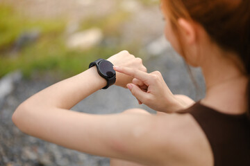 Burning calories. Cropped closeup of a fit woman looking at her smart watch counting burned...