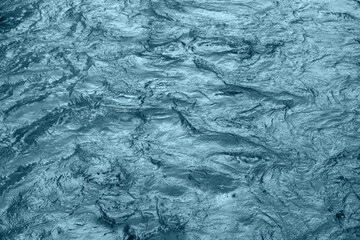 Obraz premium Abstract underwater wallpaper. Aquatic ripple wavy blue water surface, water texture background, top view.