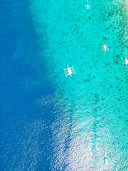 Obraz premium Beautiful beaches and hopping boats on Balikasak Island, Bohol, Philippines, a sacred place for scuba diving (traditional Philippine boats, banca)