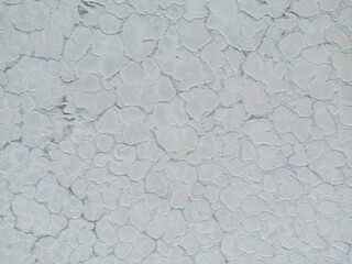 Aerial close up of the surface of the huge salt flats Salinas Grandes de Jujuy in northern Argentina while traveling South America