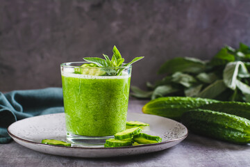 Refreshing cucumber and mint smoothie in a glass on the table