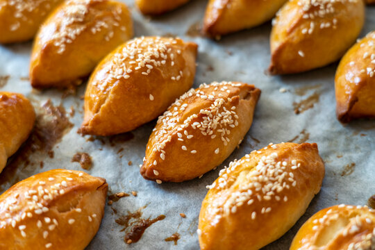 Turkish pastry pogaca with cheese filling on oven tray