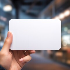 a hand holding a blank business white card