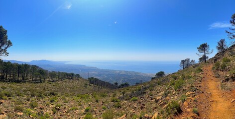 panorama view from the Pico de Los Reales over the coastline of the Costa del Sol towards the Mediterranen Sea, Paraje Natural Los Reales de Sierra Bermeja, Estepona, Andalusia, Malaga, Spain