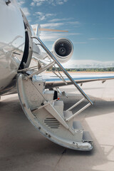 Open airstairs of a private jet at the airport. Luxury business jet 