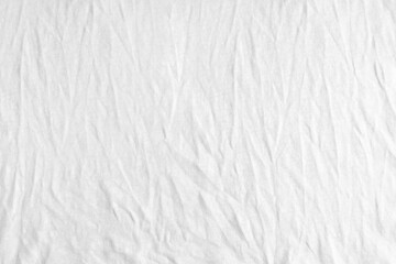 Plakat Wrinkled, crumpled white fabric texture background. Wrinkled and creased abstract backdrop of cotton jersey textile, wallpaper with copy space, top view.