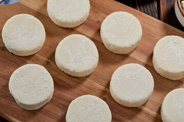 raw cottage cheese pancakes on the wooden board