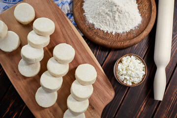 raw cottage cheese pancakes on the wooden board