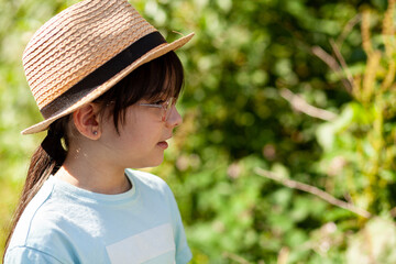 Portrait of cute asian child girl with straw hat and blue t-shirt