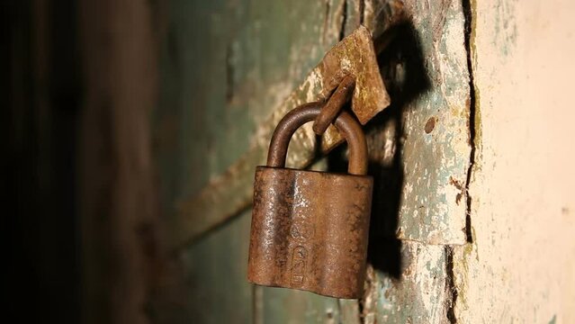 There is a big old padlock on the basement door.