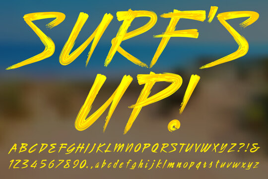 Surf's Up! A bright yellow paint brush script alphabet in surfer style.