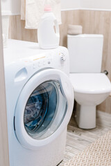 Washing gel liquid laundry detergent and fabric softener on washing machine. High quality photo
