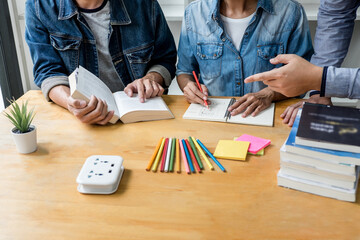 High school or college student group sitting at desk in library studying and reading, doing homework and lesson practice preparing exam to entrance, education concept - obrazy, fototapety, plakaty