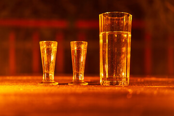 Collection of historic, vintage style glasses made from czech crystal glass form old abandoned village pub consist from two shot glasses for liquers and one big glass dedicated for water or lemonade.