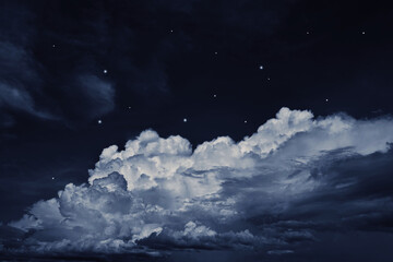 Black dark blue night sky with clouds and stars. A storm is coming, thunder, rain. Lightning flashes. Glow. Dramatic.