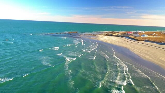 Aerial Shot Of Man Kitesurfing On Turquoise Sea Waves, Drone Flying Forward Over Coastline On Sunny Day - Baja California, Mexico