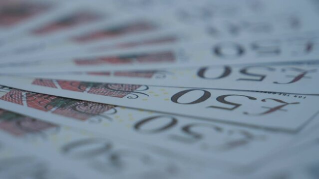 A close up view of 50 pound bank notes.