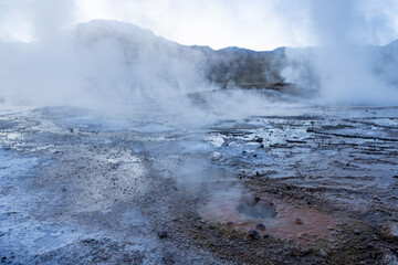 Fototapeta na wymiar Exploring the fascinating geothermic fields of El Tatio with its steaming geysers and hot pools high up in the Atacama desert in Chile, South America