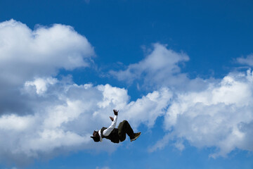 young man somersaulting. wide sky and writing field