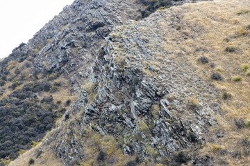 A close up image of rock strata making up the Southern Alps mountains of Lindis Pass in New Zealand.