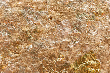 The gold leaf that was placed on the Buddha image