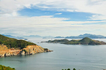 Fototapeta premium Scenic seascape and mountain scape of Vinh Hy Bay surrounding lush green tree tropical forest enclosed by Nui Chua National Park, Ninh Chu Beach, northeast of Ninh Thuan Province, Vietnam