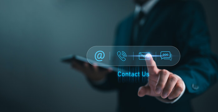 Contact us or Customer support hotline, people connect. Businessman touching on virtual screen contact icons (email, address, live chat, telephone). Customer service, helpdesk advice online support
