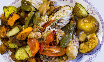 Baked chicken with vegetables and apples seen from above