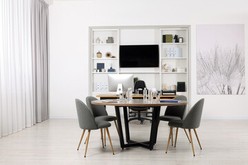 Stylish office with comfortable furniture and tv zone. Interior design