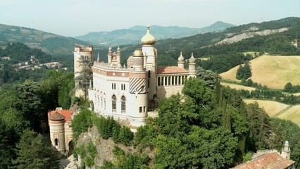 Aerial drone panoramic view of the Rocchetta Mattei castle in Italy on sunny summer day, view from above. High quality 4k footage