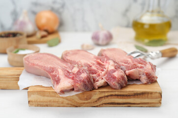 Raw beef tongue pieces on white wooden table, closeup