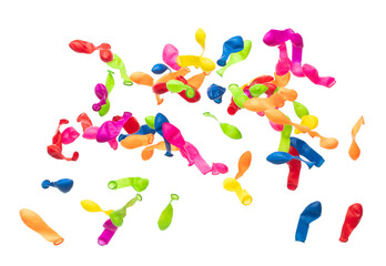 Deflated rubber colorful balloons fly in air. Many colorful deflated balloons in red, blue, yellow throw scatter. Toy for kid to play in birthday party and celebrate, white background isolated