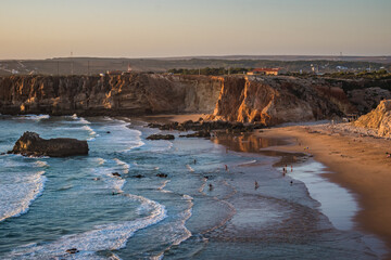 Sea waves with sunset colors on the sand and cliffs of Tonel beach, Sagres - Algarve PORTUGAL