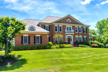 Large Brick Houses in suburb at Summer in the north America. Luxury houses with nice landscape.