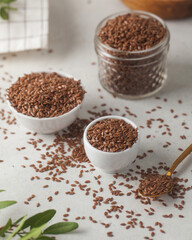 Brown flax seeds in glass jars. Superfood, healthy eating. 