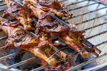 Grilled chicken traditional style on the charcoal stove.