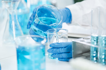 medicine research in chemical laboratory, chemist scientist working with liquid experiment test analysis by using scientific tube beaker glassware, chemistry science pharmaceutical medical lab concept