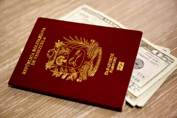 Venezuelan passport with United States twenty dollar bills tucked into it