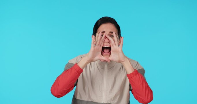 Shouting, announcement and alert with a woman on a blue background in studio for attention or warning. Portrait, screaming and hands over mouth with a young female person yelling a loud message