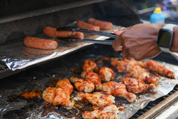 Sizzling skewers of beef, pork, chicken, and shrimp grilling over an open flame, representing indulgence, gathering, and culinary delights hot dogs and hamburgers too 