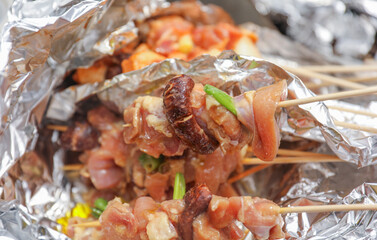 Sizzling skewers of beef, pork, chicken, and shrimp grilling over an open flame, representing indulgence, gathering, and culinary delights hot dogs and hamburgers too 