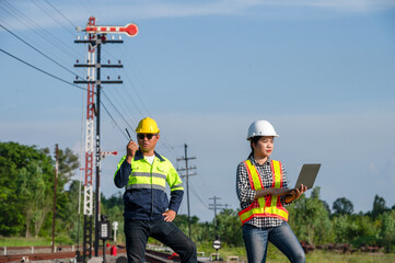 Asian railway engineer inspects a train station Engineer working on maintenance inspection in railway station