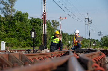 Asian railway engineer inspects a train station Engineer working on maintenance inspection in railway station