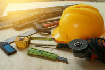 Various hand tools are placed on the wooden floor.